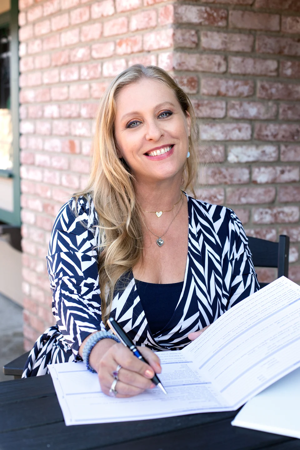 Julianne reviewing insurance paperwork at a table
